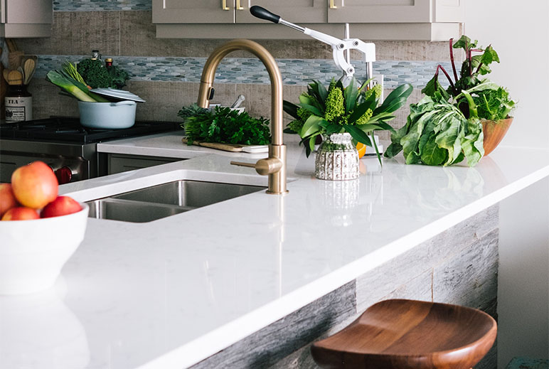 White Engineered Stone Countertop with under-mounted sink and taps