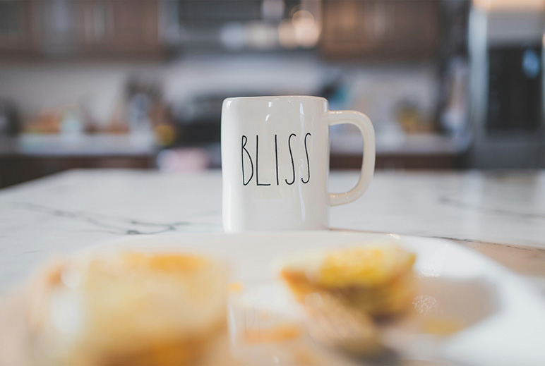 Calacatta Gold countertop with coffee mug and cakes